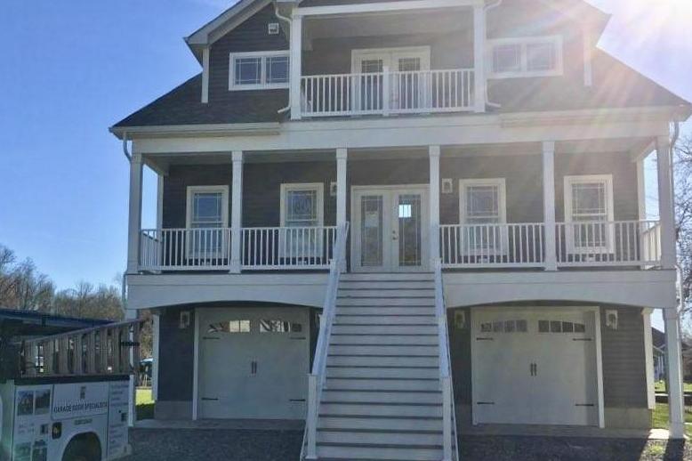 Carriage House Stamped single bay doors with arched glass.